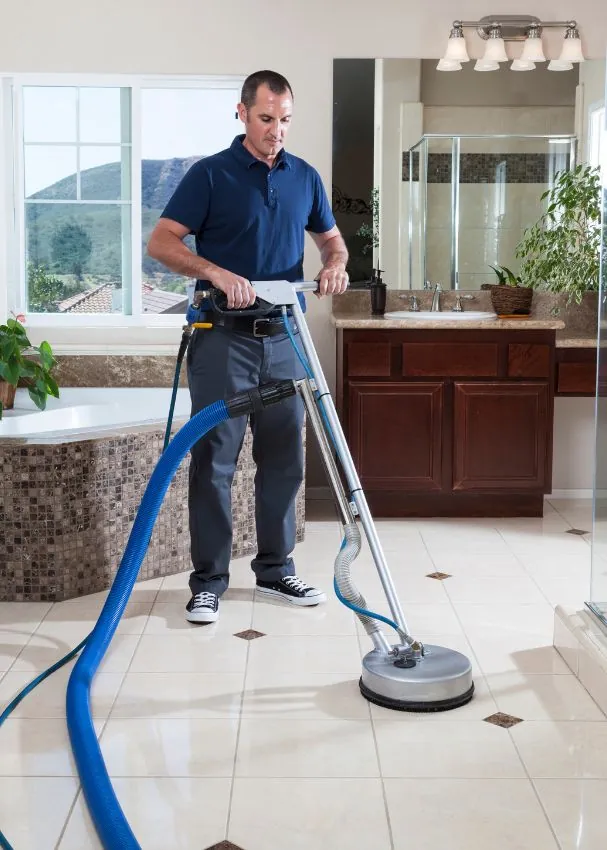 Professional cleaning a tiled floor